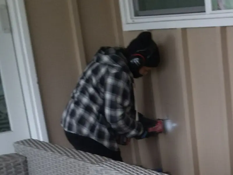Professional electrician installing an exterior outlet in Rockwell